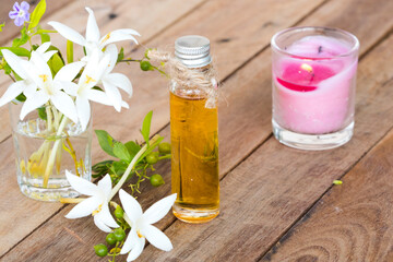 herbal essential oils aromatherapy extract flowers cock tree local flora of asia and candlelight of lifestyle relaxation decoration on background wooden
