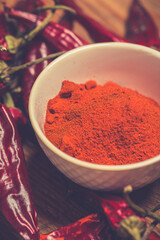 Dry Red Hot Chili Peppers over wooden background