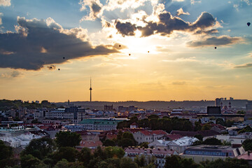 anorama of Vilnius at sunset in August 2020. City buildings. Skyscrapers on the horizon. Blue sky over the city. Clouds and sun at sunset. Summer evening. A quiet day at the weekend