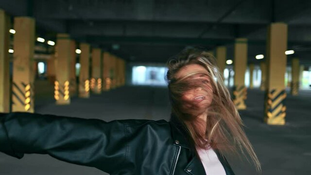 Hipster woman street dancer dancing at urban parking slow motion. Shot on RED Raven 4k Cinema Camera