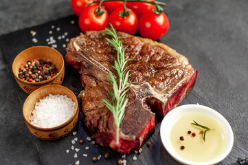 grill t-bone steak with ingredients on stone background