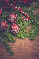 Christmas composition. Fir branches on wooden background. Flat lay, top view, copy space. Christmas still life. Christmas frame made of fir branches and pink toys. Greeting card. Happy New Year