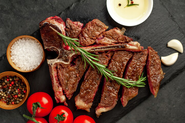 grill t-bone steak with ingredients on stone background