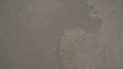 The process of priming the floor with a solution. Waterproofing a concrete floor. repair cracked...