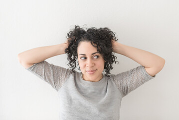 A Woman With Curly Hair Looks To the Side