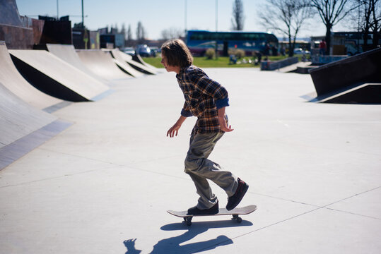 Young boy riding a skateboard in the skate park