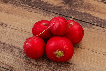Ripe fresh radish heap over wooden