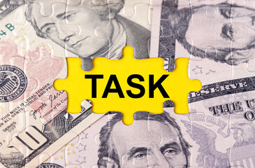 Fototapeta premium Puzzle with the image of dollars in the center of the inscription -TASK