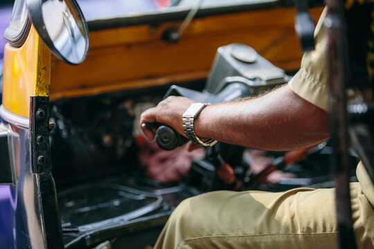 Detail of the hand and arm of an autorickshaw driver in India