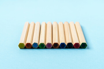 Close up Wooden Color pencils on blue background close up with Clipping path.Beautiful color pencils.Color pencils for drawing Rainbow color pencil and used as a background. Top view copy space