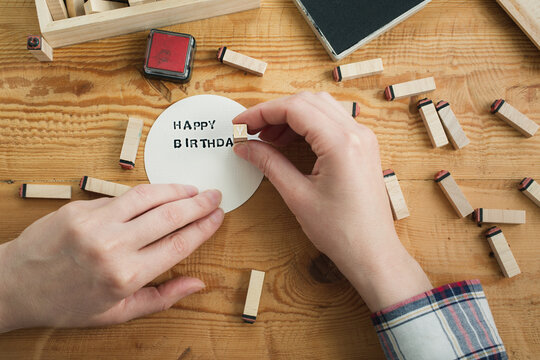 Woman at work stamping types