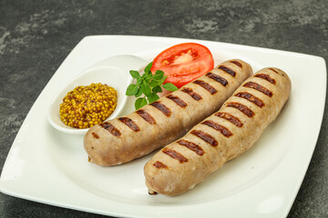 Grilled natural pork sausages with sauce