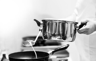 Chef cooking in a kitchen, chef at work, Black & White.