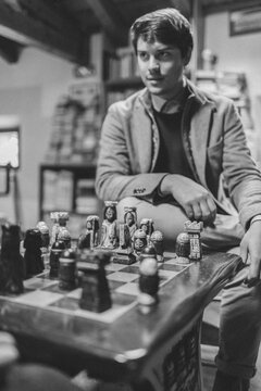 Best Friends Playing Chess into a College Library