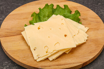 Sliced yellow cheese over board