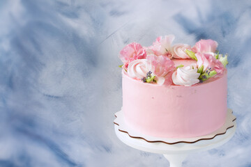 Pink cake. Meringues and pink flowers on the top of cake . Concept for Wedding , St. Valentine's Day, Mother's Day, Birthday Cake. Beautiful cake on stand