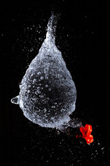 red balloon falling into water