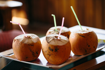 Coconut drinks on a tray with colored straws