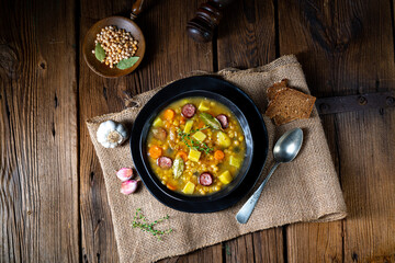 Rustic pea soup with bacon and sausages