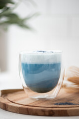 blue matcha tea with latte foam in a glass