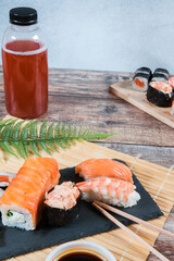 Sushi rolls and a bottle of fresh juice