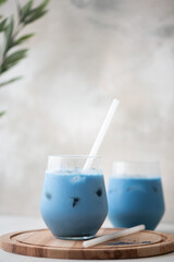 iced blue matcha tea with milk in glass on a board