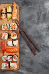 Sushi Set nigiri and sushi rolls on wooden plate