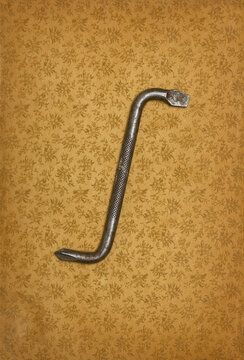 Old offset screwdriver on old paper with floral pattern