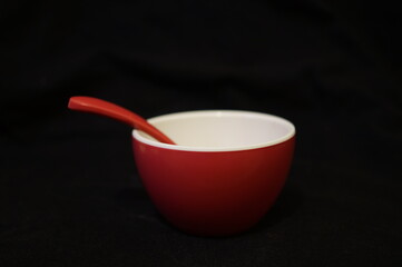 A small red dish and spoon