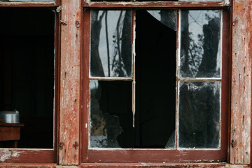 Broken window of an abandoned house