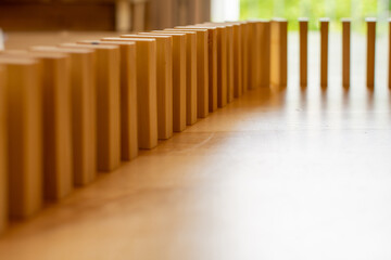 Wooden block domino standing stable on wood table, business chain and connection symbol, domino...