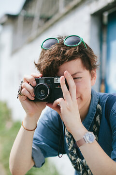 Stylish woman takes pictures with a vintage camera