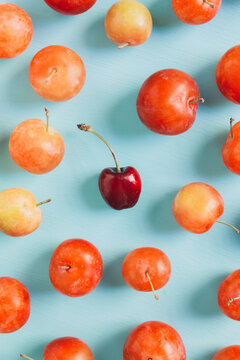 A single cherry and plums