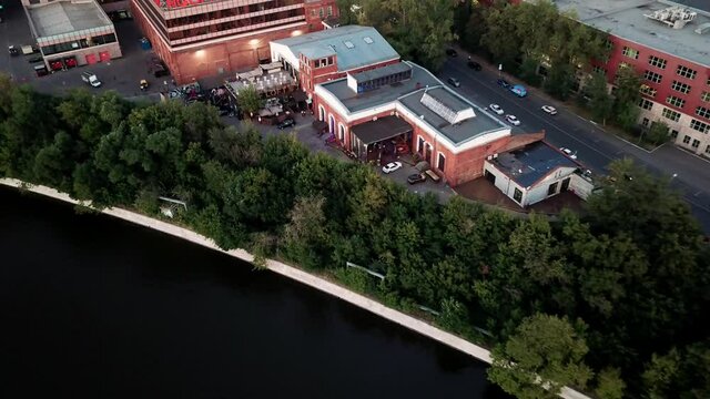 bird's-eye view of brown brick building on the shore of a reservoir