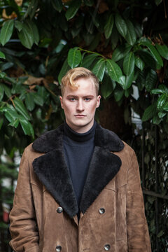 stylish blonde man wearing sheepskin coat in Paris