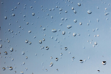 Rain drops on the window, blue sky texture