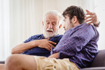 Differences of two generations male elder father with younger man son serious talking consulting together or telling history story at home.