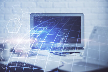 Double exposure of desktop with computer and world map hologram. International data network concept.
