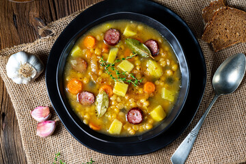 Rustic pea soup with bacon and sausages