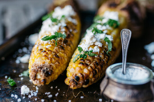Grilled corn with feta cheese topping