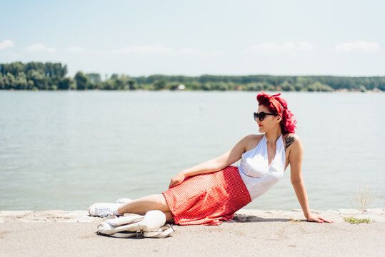 Young woman enjoying a sunny day at the river bank