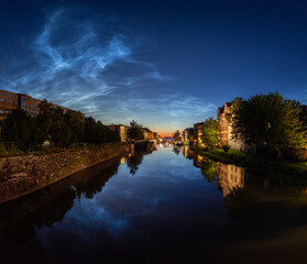 Fototapeta na wymiar Noctilucent clouds above Opole old City.