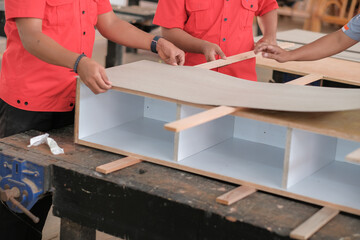 Carpenter installing cabinets a laminate counter top