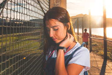 Caucasian girl posing with a blue overalls and white shirt.