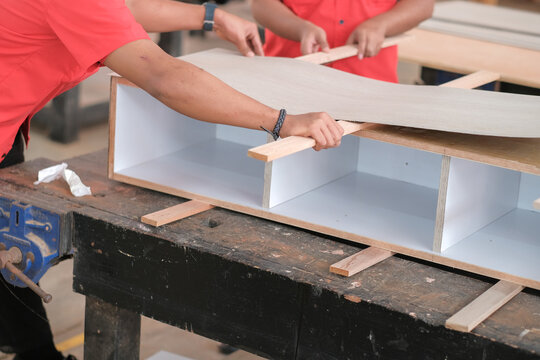 Carpenter Installing Cabinets A Laminate Counter Top