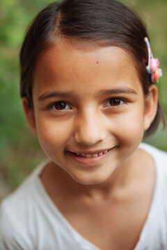 Portrait of a young girl smiling and looking at camera.