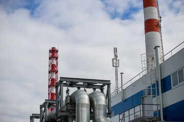 Territory of thermal power plant, red pipes, industrial buildings