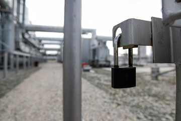 Gate locked with padlock at abandoned factory