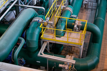 Interior of urban thermal power plant, industrial turbines, pipes