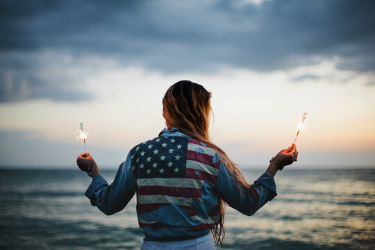 Woman holding sparklers in the dark